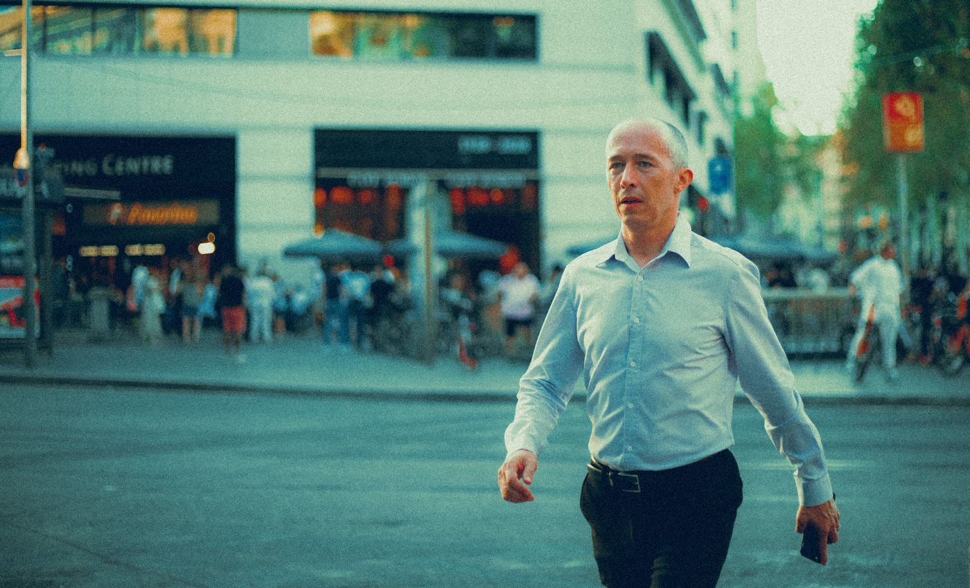 Selbstbewusster Mann geht durch eine europäische Stadtstraße
